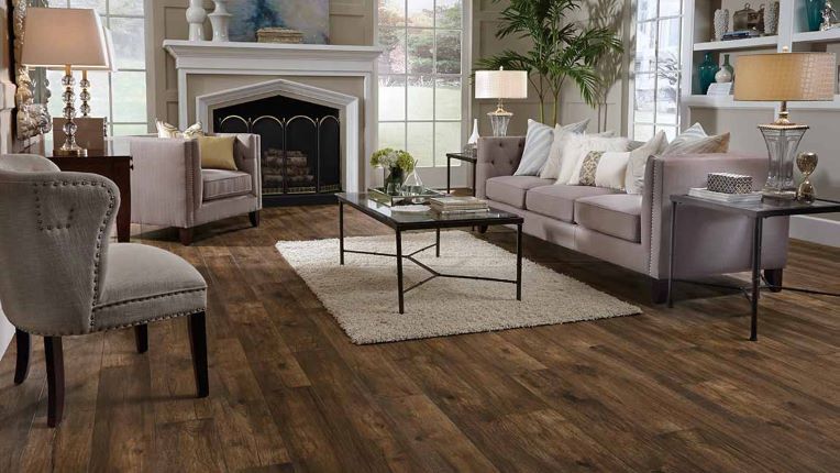 classic dark stained wood look laminate flooring in an elegant formal living room with a fireplace